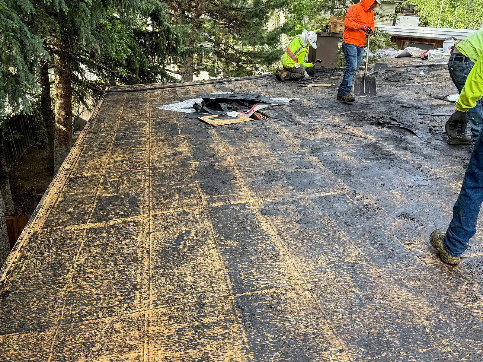 Existing ballast and membrane being removed from a low-slope roof